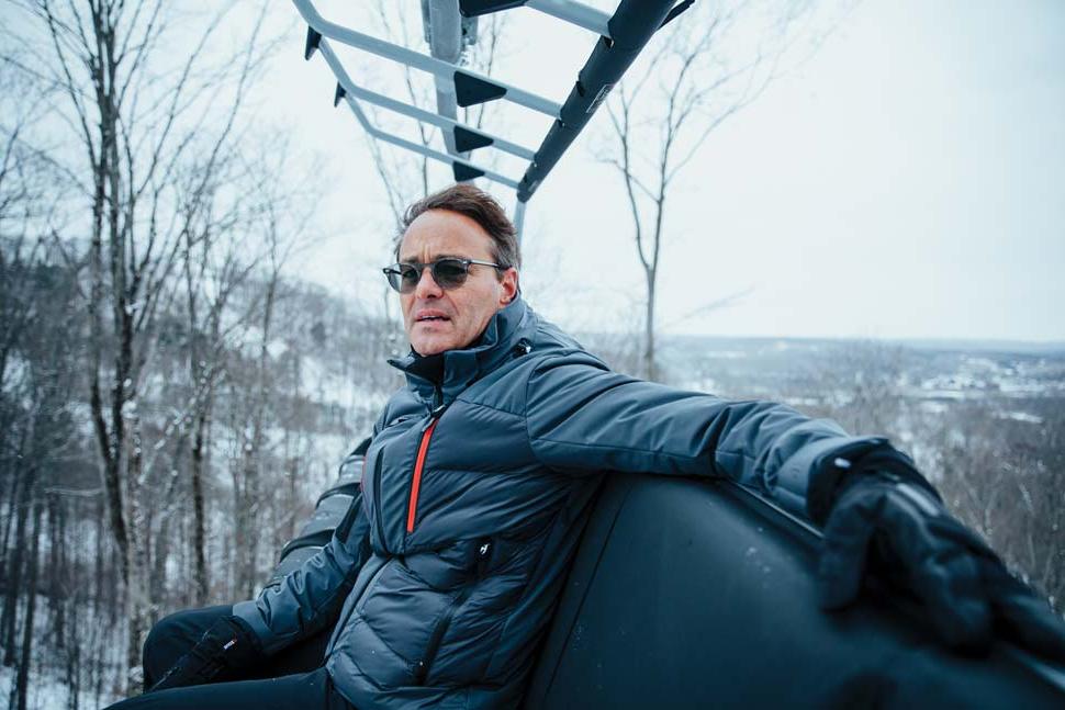 Stephen Kircher seated on a chairlift